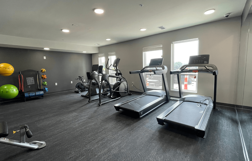 a gym with treadmills and other exercise equipment