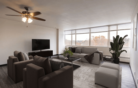 A living room with a brown sofa set and a television.