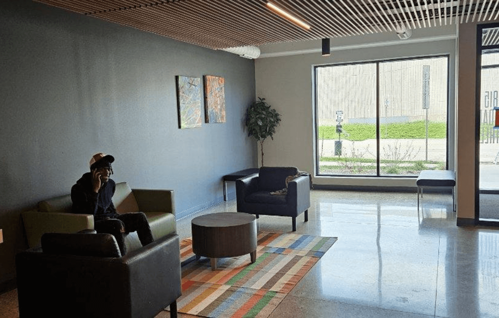 a woman sitting on a couch in a lobby