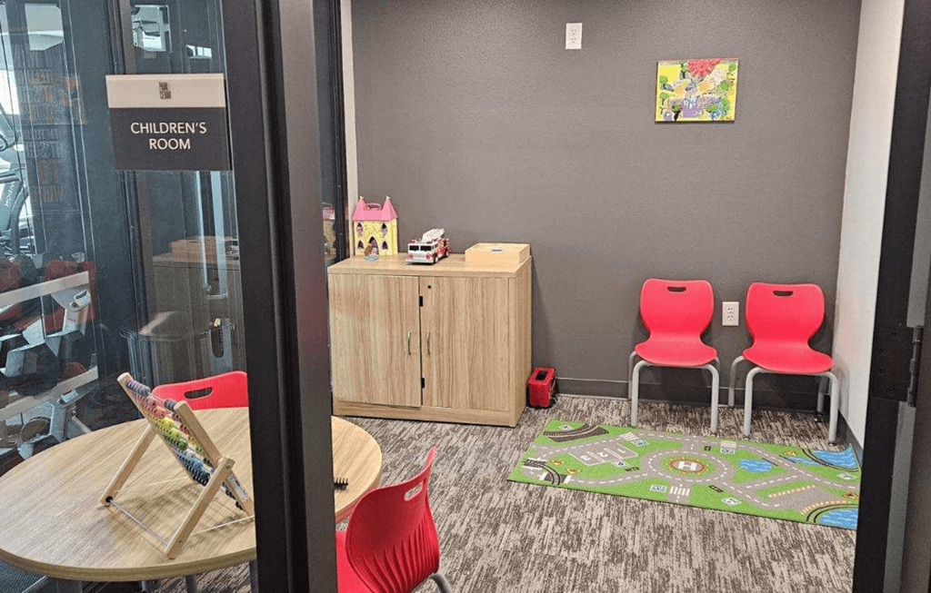 a childrens room with chairs and a table
