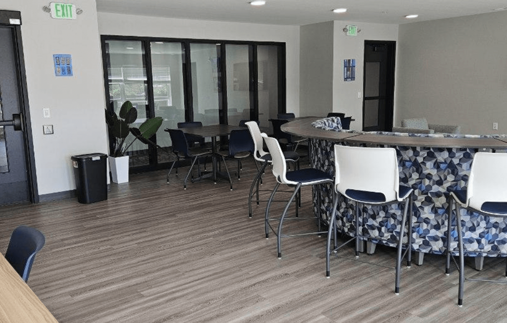 a room with chairs and a bar and a table