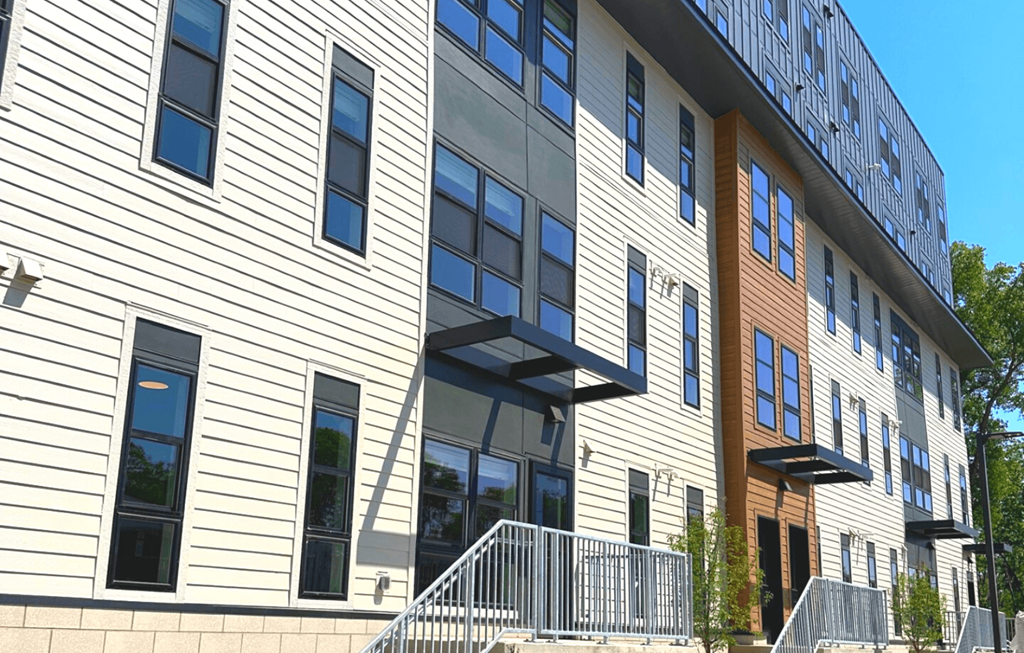 a large apartment building with a staircase in front of it