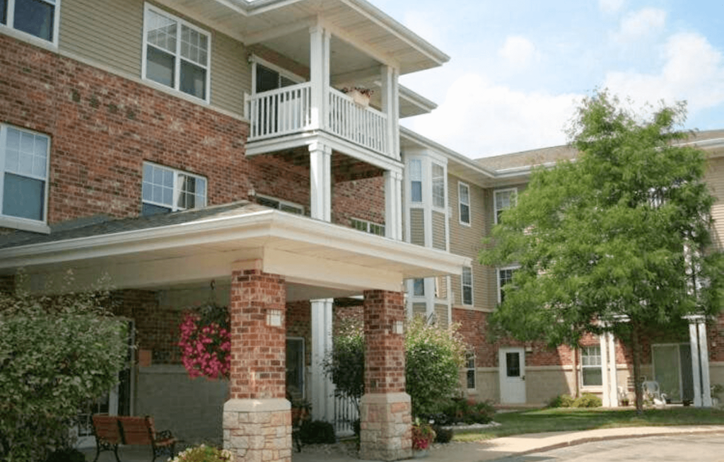 an apartment building with a porch and a dog on the balcony
