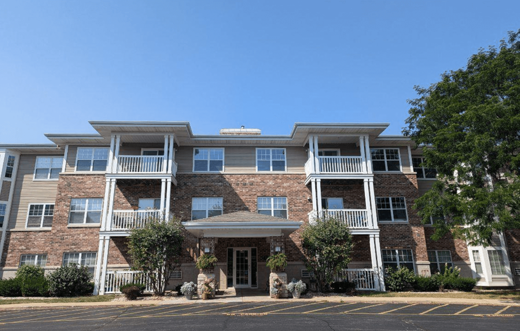 a large brick apartment building with trees in front of it