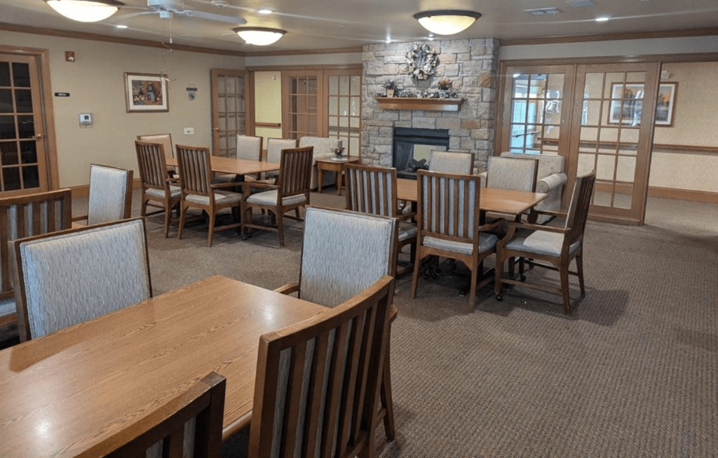 a dining room with tables and chairs and a fireplace