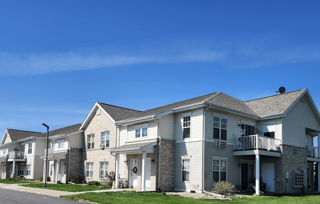 A row of houses with a clear blue sky above them.