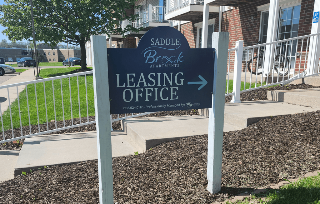 A sign for the leasing office of Saddle Brook Apartments.