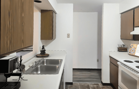 A modern kitchen with a white countertop and brown cabinets.