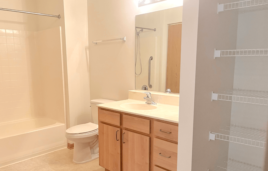a bathroom with a toilet sink and shower