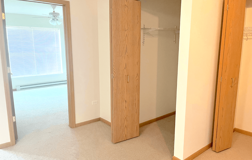 a bedroom with a closet and a window