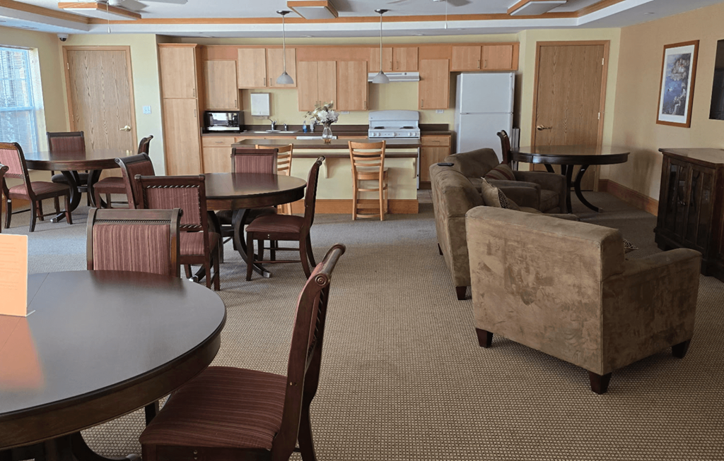 A kitchen with a table and chairs in the foreground.