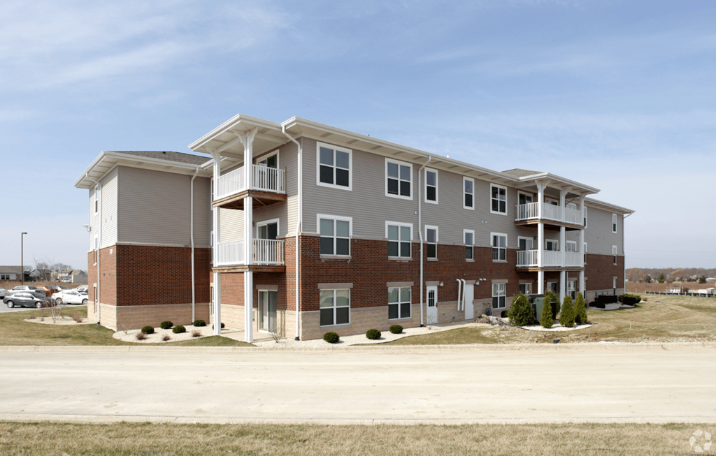 A large apartment complex with multiple balconies and doors.