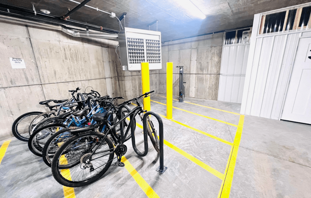 a row of bikes parked in a parking garage
