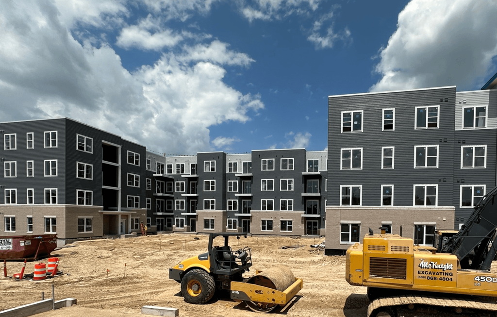 an image of a construction site with buildings and a bulldozer