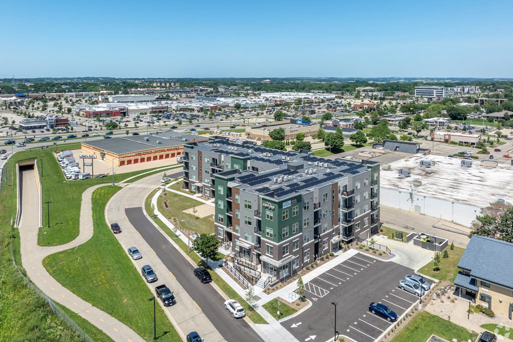 A parking lot with cars and a building in the background.