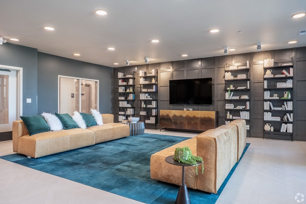 A living room with a large couch and a television.
