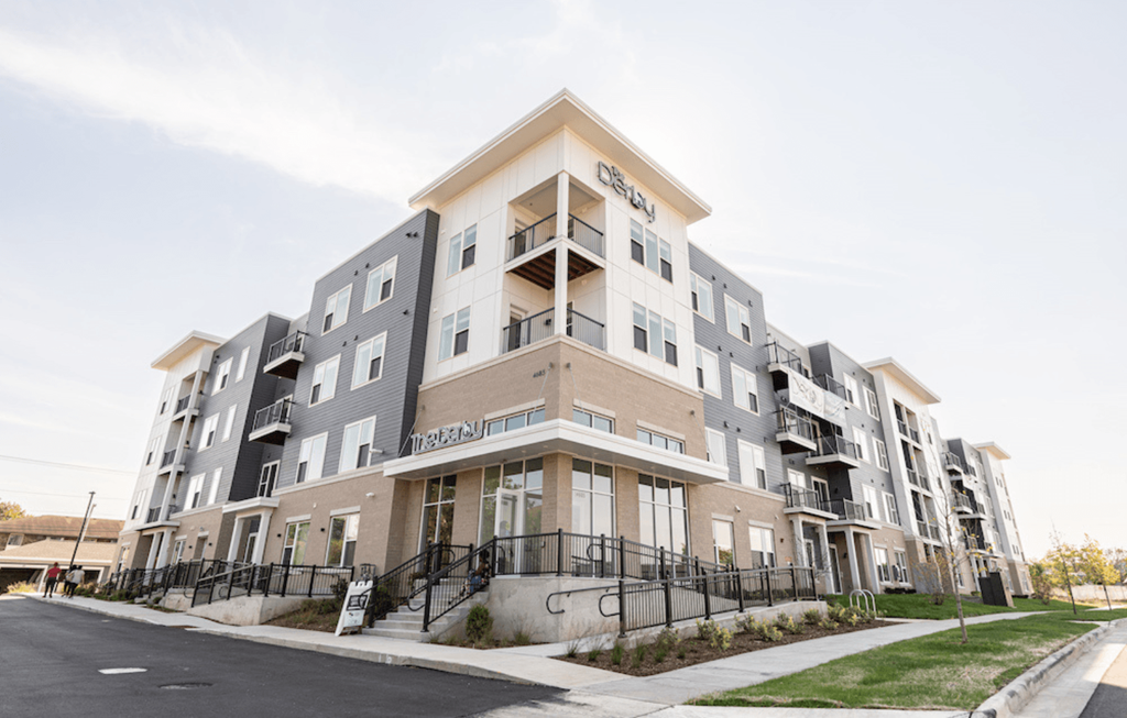 a new apartment building with balconies and a sidewalk