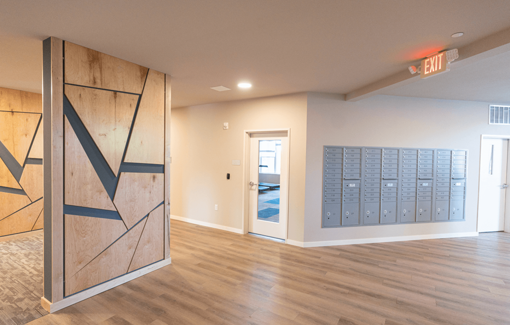 a lockers room in a renovated basement with wood flooring and a wall with
