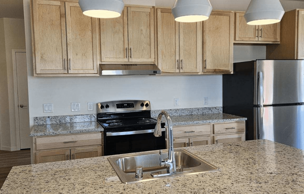 a kitchen with granite counter tops and a sink