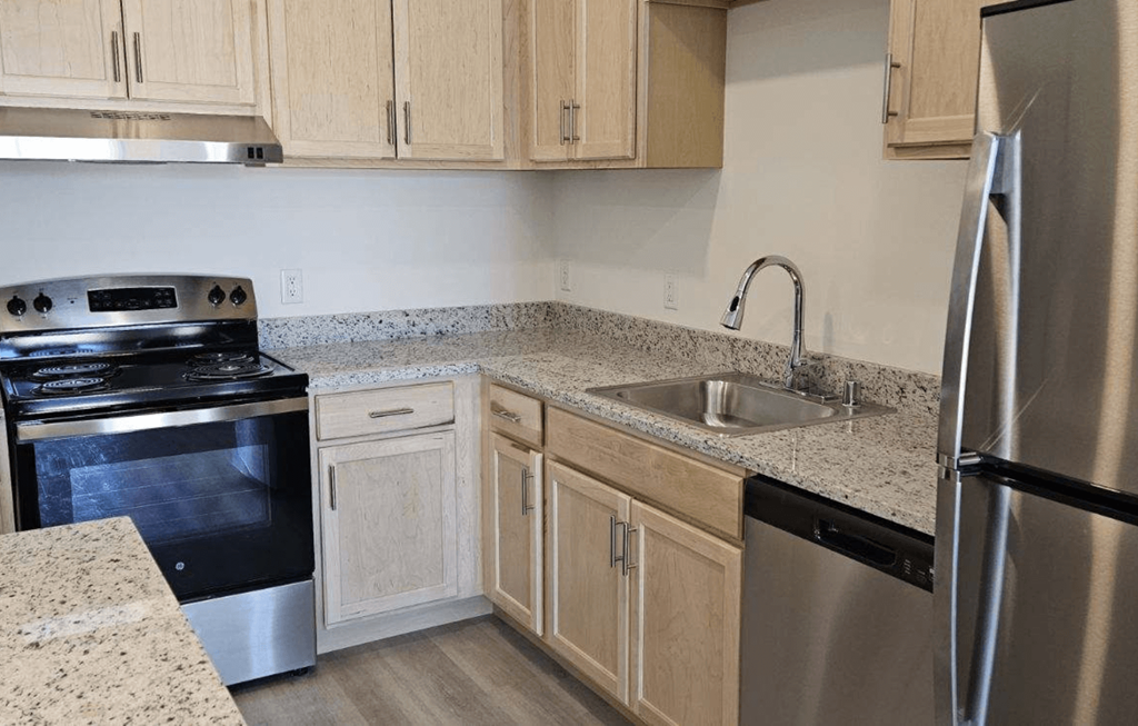 a kitchen with granite counter tops and stainless steel appliances