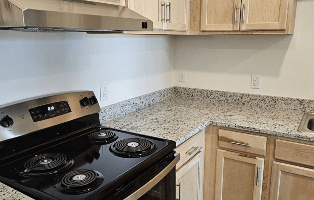 a kitchen with granite counter tops and a black stove