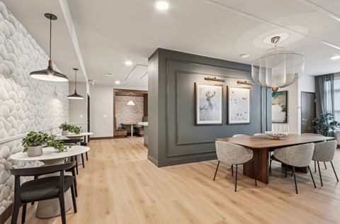 A modern dining room with a wooden table and chairs.