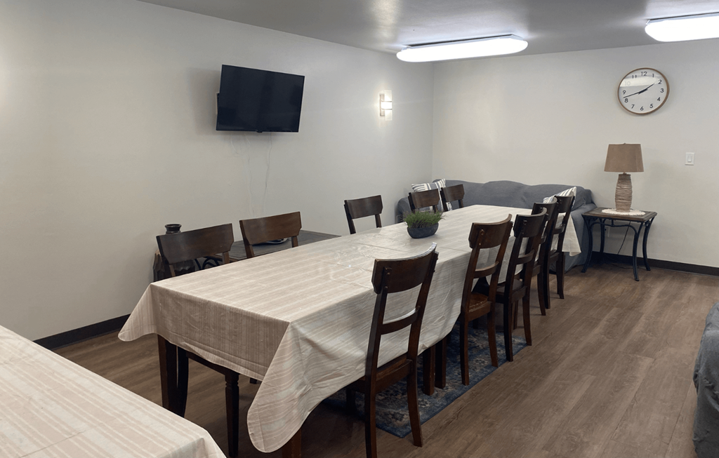 A conference room with a long table and chairs.