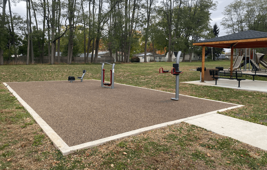 A playground with a swing set and a seesaw.