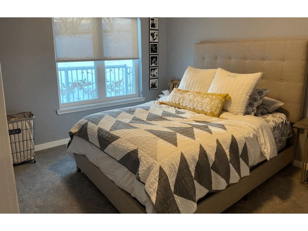 a bedroom with a bed and a window