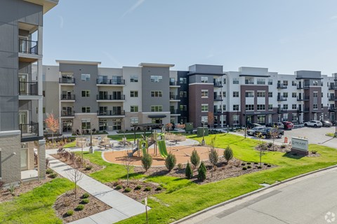 Apartment complex with a playground in the front.