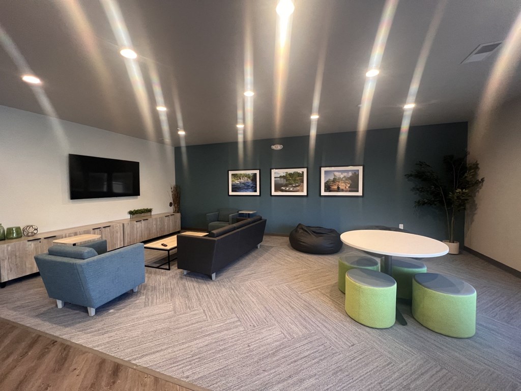 a living room with couches and chairs and a tv