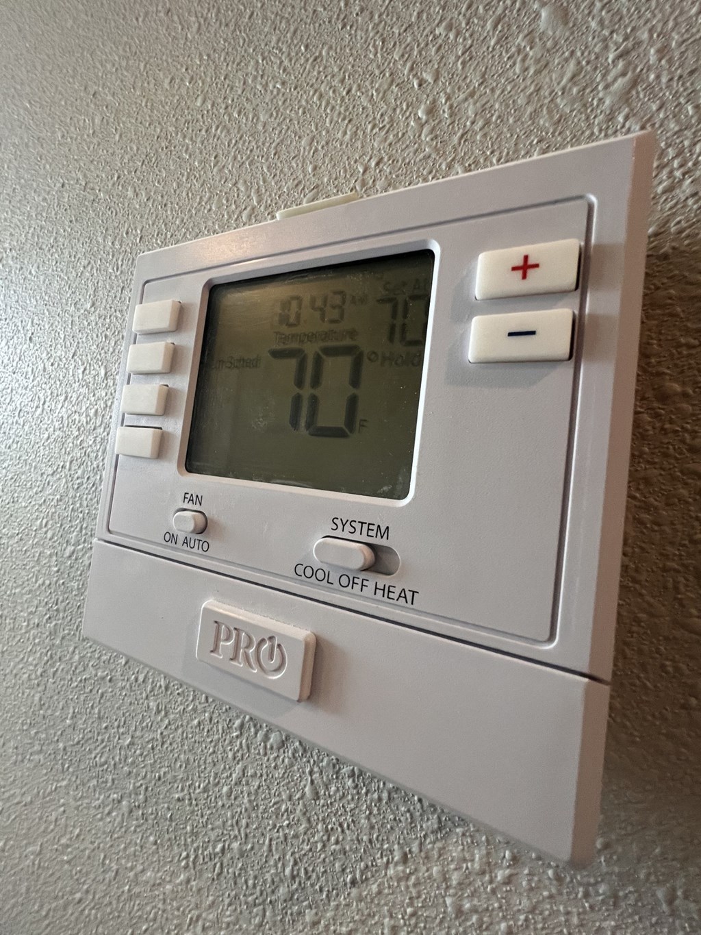 a digital thermostat on a wall
