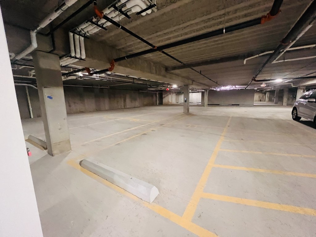 a parking garage with a car parked on the side of the road