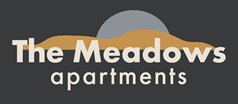 The Meadows Apartments logo with a sunset in the background.