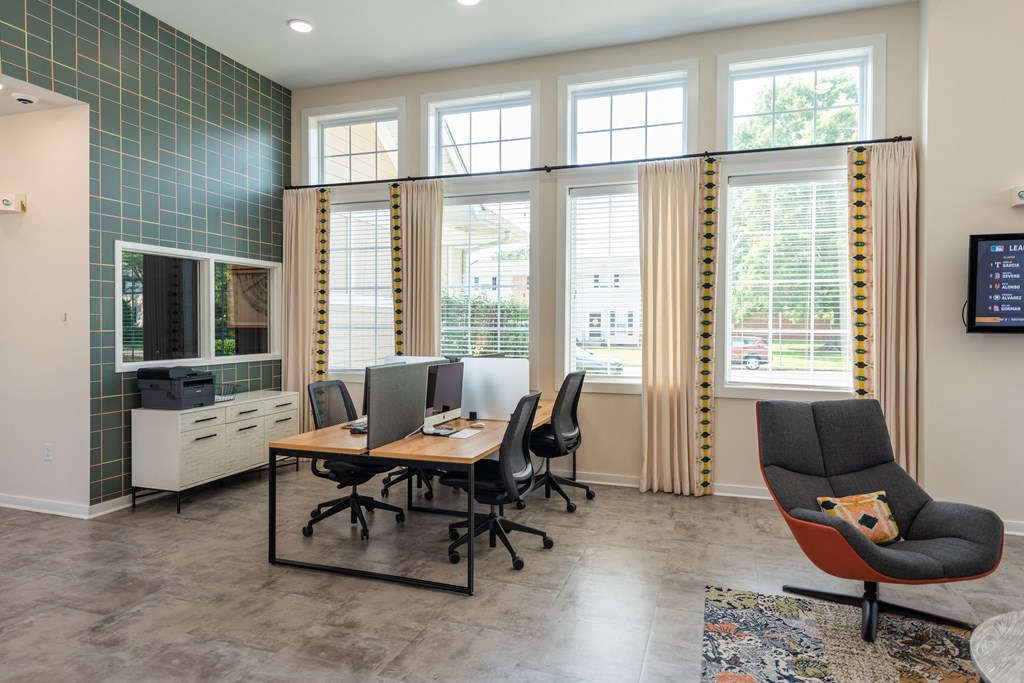 a conference room with a desk and chairs and a tv