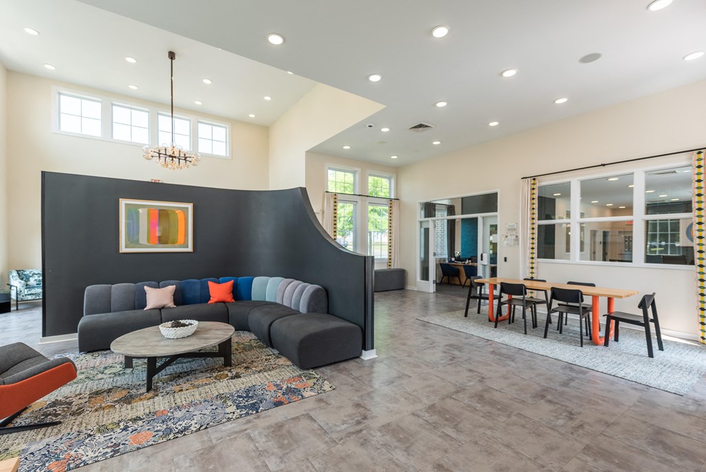 a living room with a couch and a table with chairs