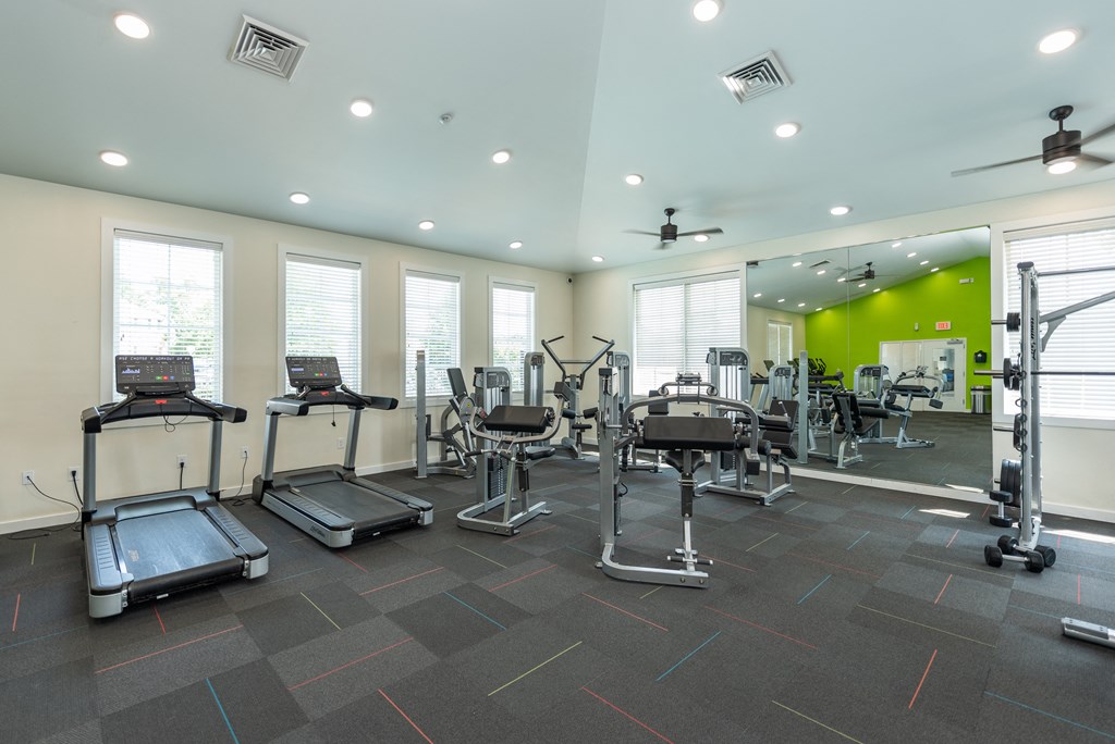 a gym with treadmills and other exercise equipment