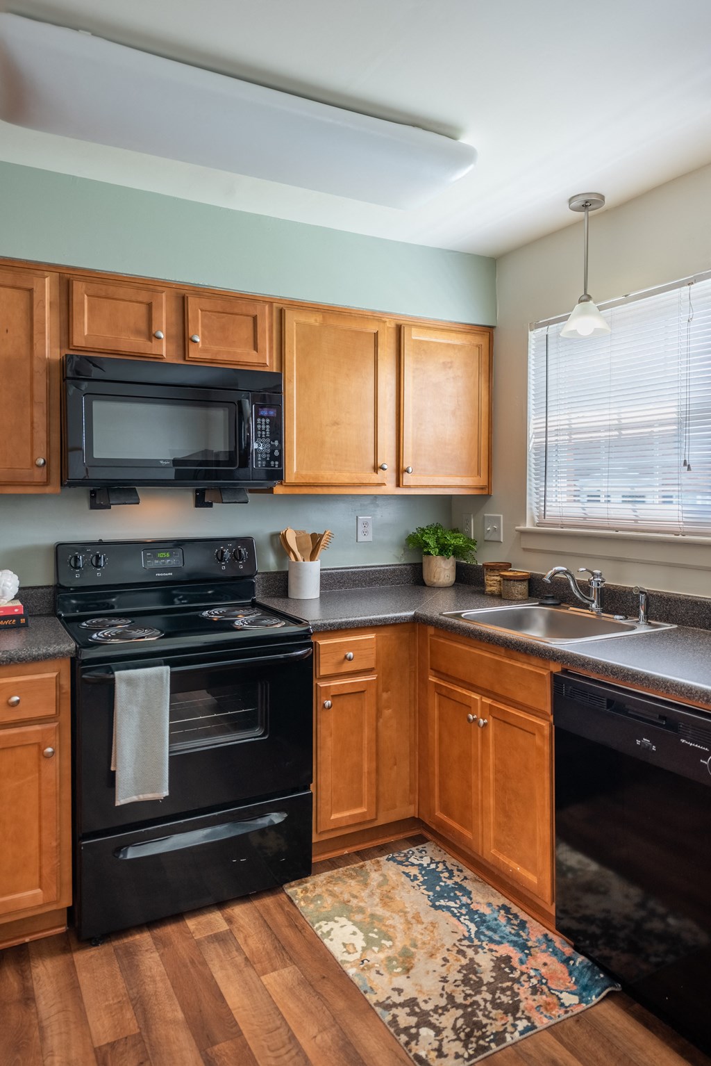 a kitchen with black appliances and wooden cabinets