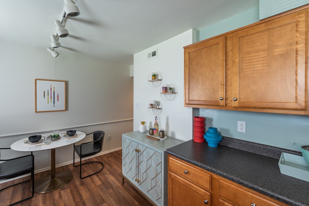 a kitchen with a counter top and a table with a chair