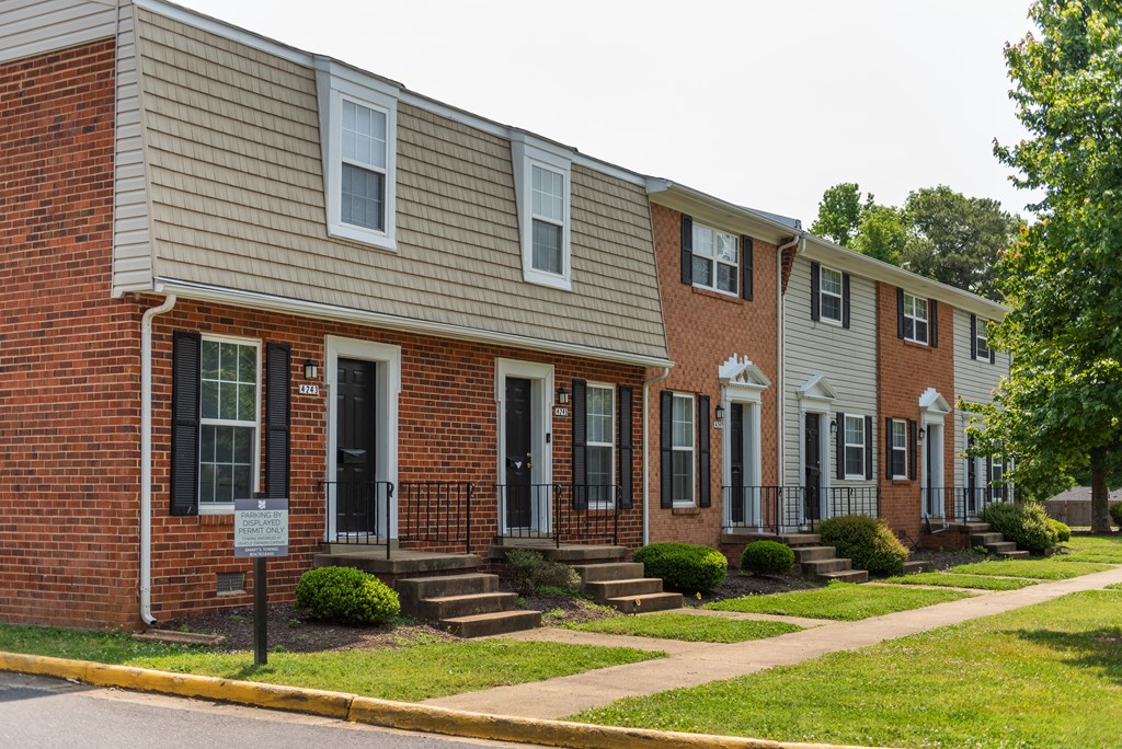 a row of town houses on the side of a street
