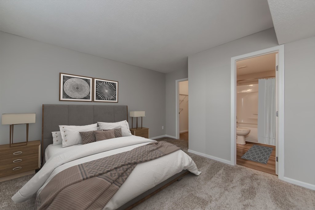 A bedroom with a large bed and two lamps.