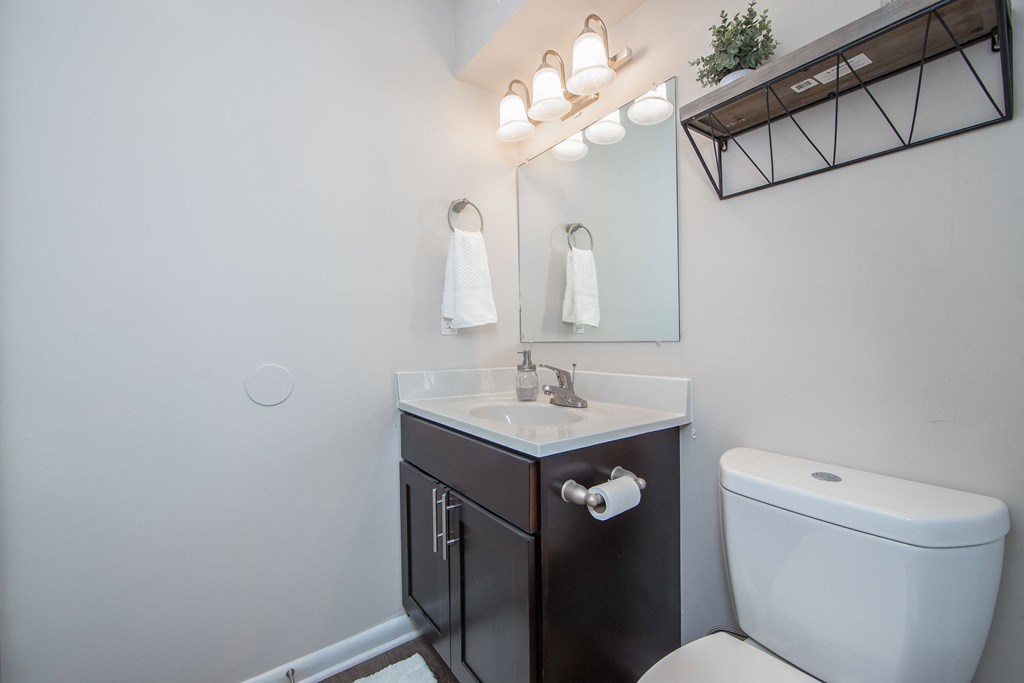 Bathroom with single sink cabinet and toilet in Brittany Place Apartments in Norfolk VA