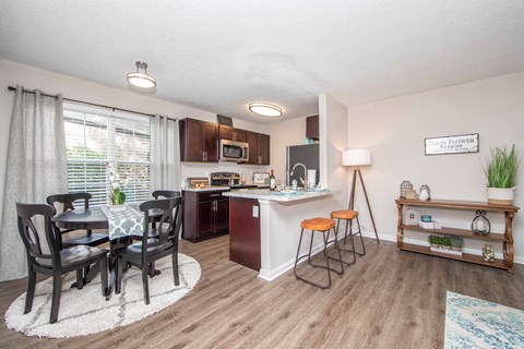a kitchen and dining room with a table and chairs
