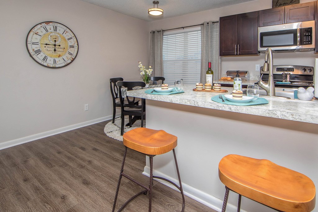 kitchen and dining room with orange stools Brittany Place Apartments in Norfolk VA