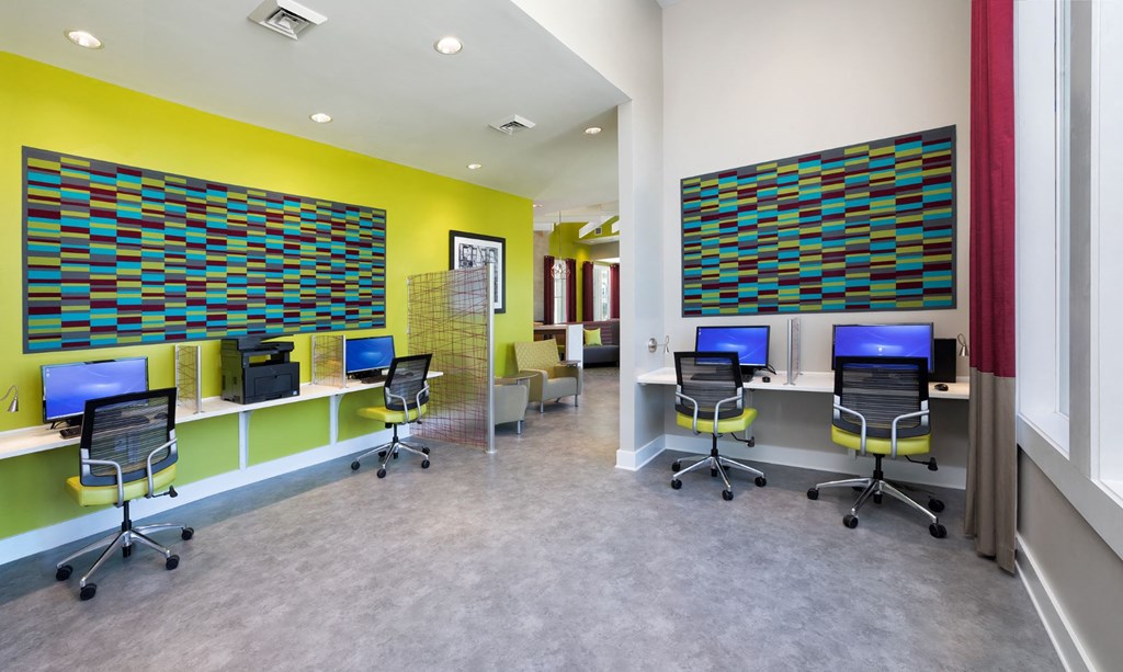 a large office space with desks and chairs and a yellow wall