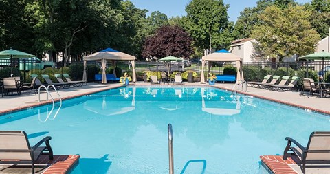 Pool with cabanas and lounge chairs