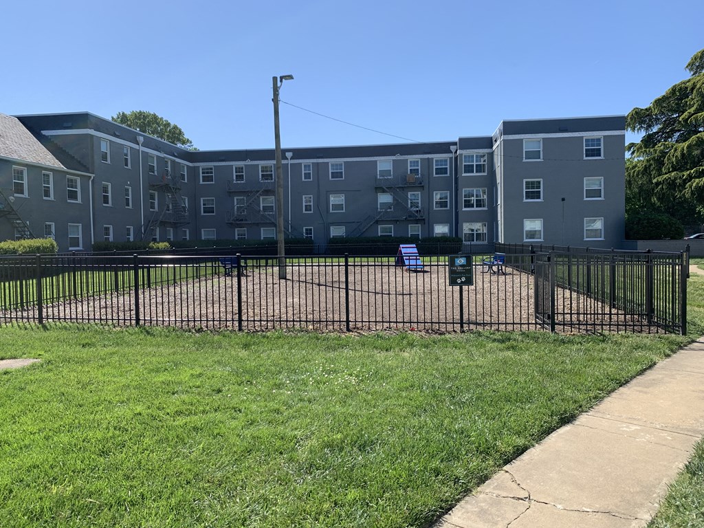 a fence in front of an apartment building