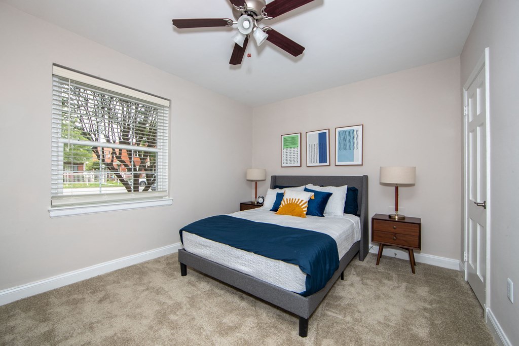 a bedroom with a bed and a ceiling fan
