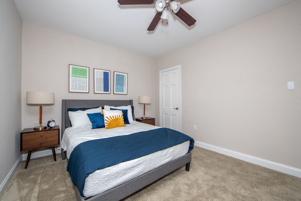 a bedroom with a bed and a ceiling fan