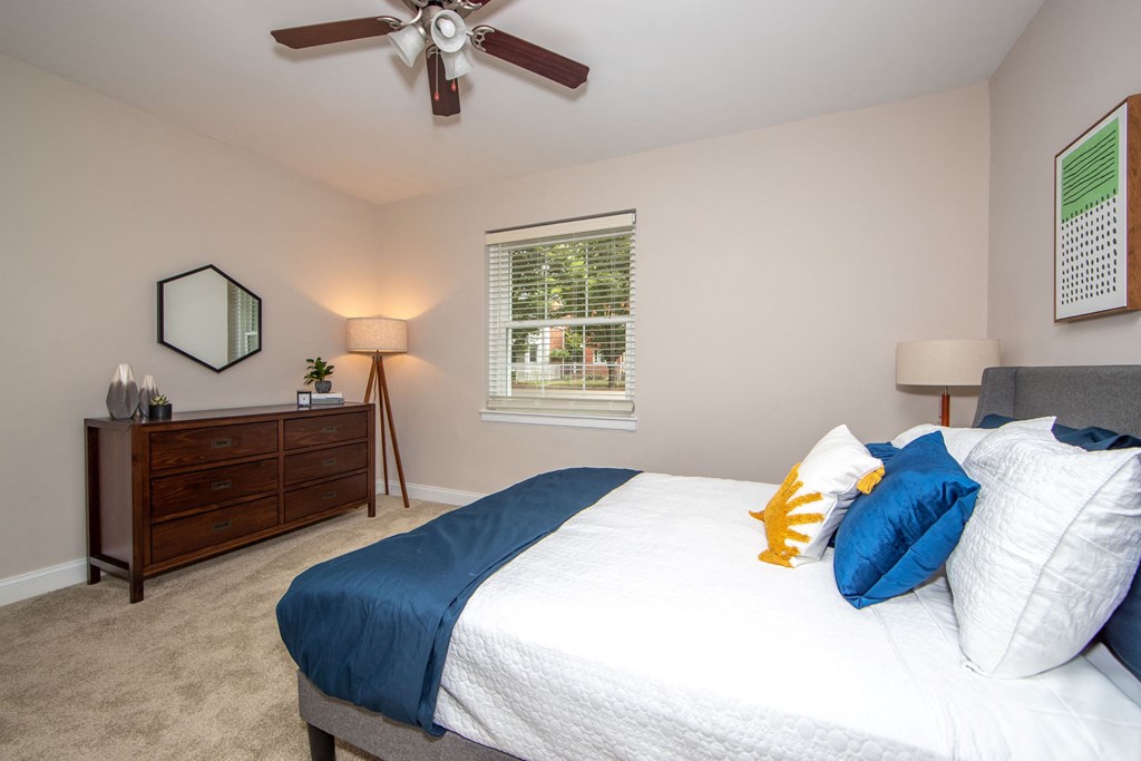 a bedroom with a large bed and a ceiling fan